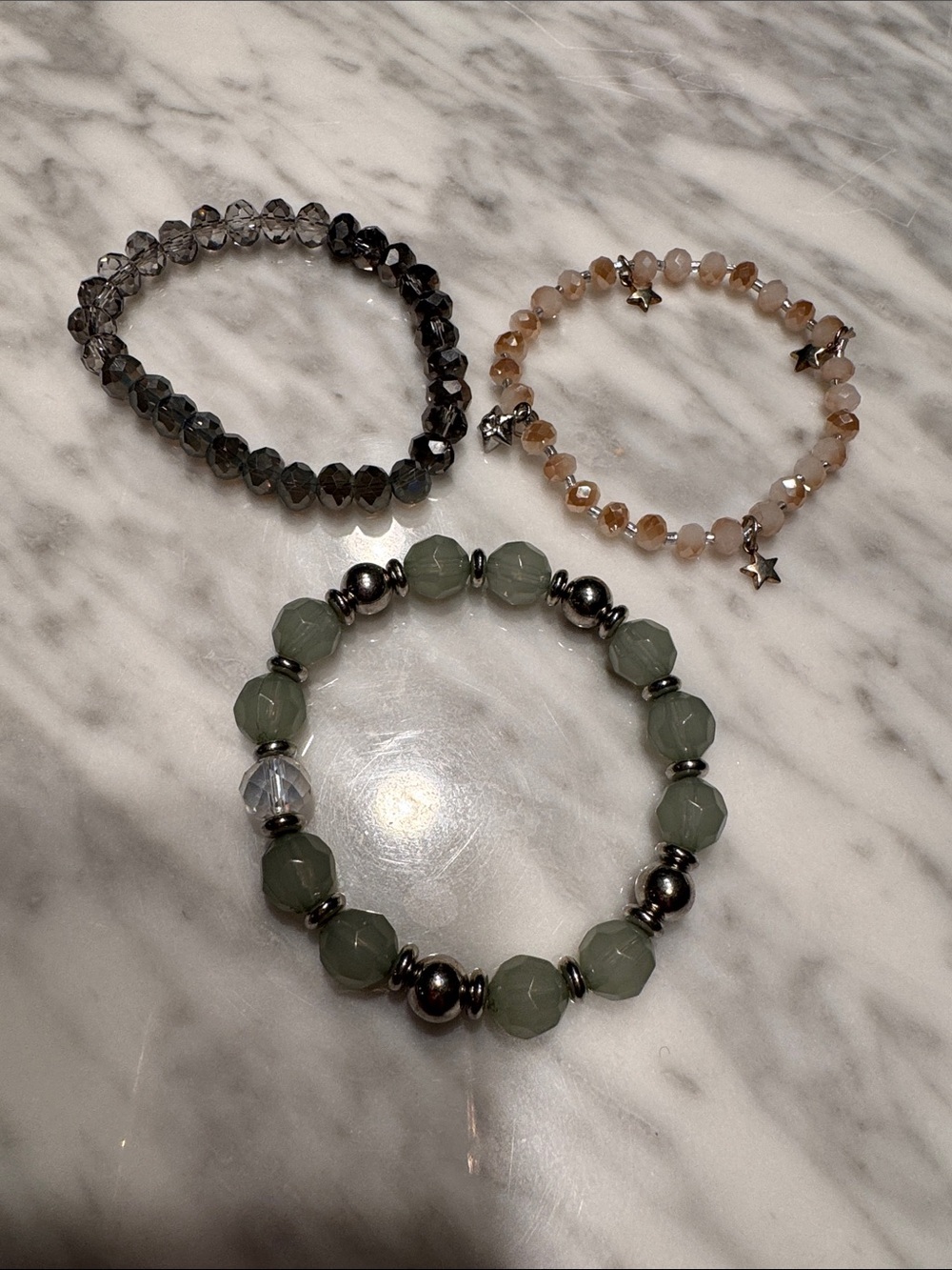 Set of 3 faceted crystal, silver, dangle star beads stretch bracelets.